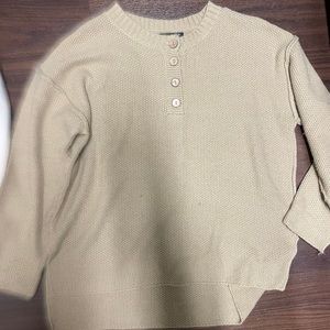 Tan sweater with buttons.